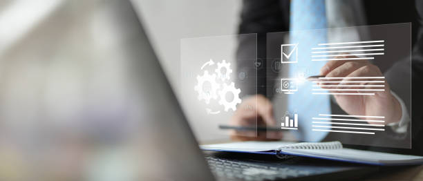 istock Automation concept. Businessman using laptop with automation icon on virtual screen 2098558586