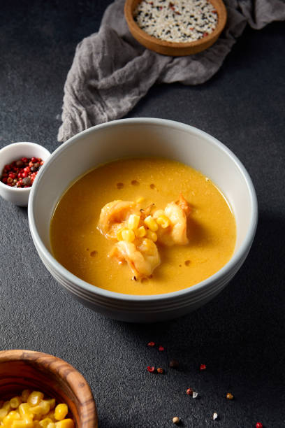 istock Shrimp and corn curry in a grey bowl with side condiments, a focus on modern Asian cuisine 2098583024
