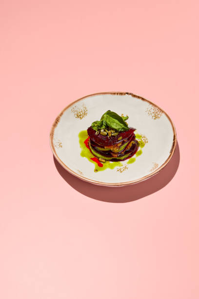 istock Beetroot mille-feuille with pesto sauce on a chic plate against a coral pink backdrop, a delight for gourmet vegetarian cuisine 2098583045