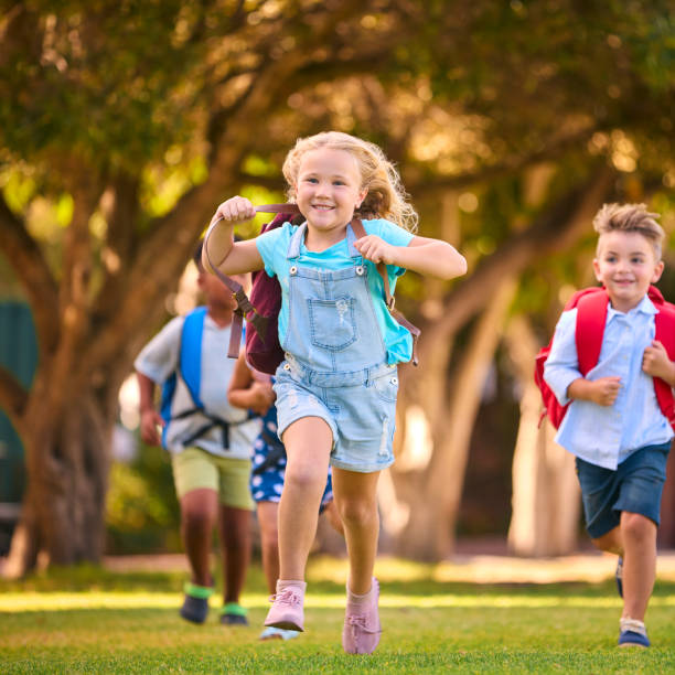 istock Multi-Cultural Primary Or Elementary School Students With Backpacks Running Outdoors At End Of Day 2098597703
