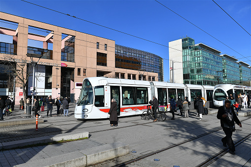 Lyon, France-02 23 2024: Tramways crossing in front of the Lyon Part-Dieu railroad station, France.