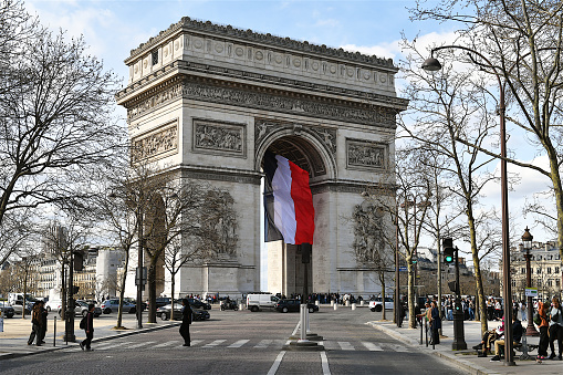 Paris, France-03 19 2024: People passing in front of the Arc de Triomphe in Paris, France.