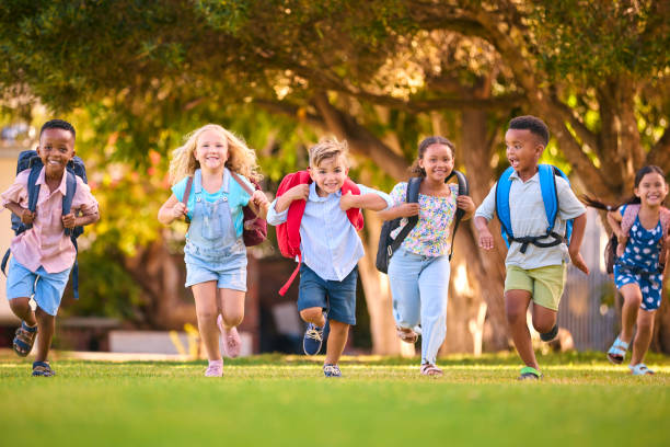 istock Multi-Cultural Primary Or Elementary School Students With Backpacks Running Outdoors At End Of Day 2098602857