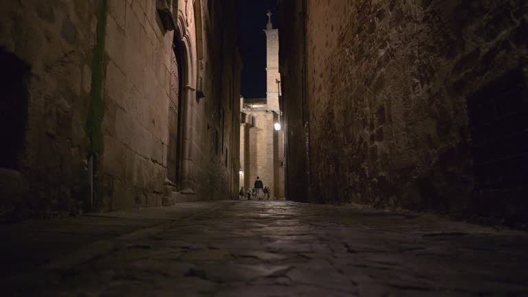 Nighttime stroll through the historic streets of Caceres old town, Spain