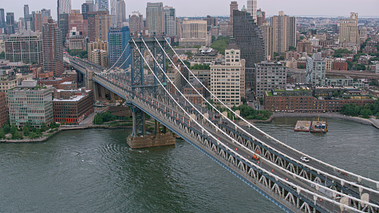 Aerial view of Manhattan Bridge over East River surrounded by skyscraper buildings, New York City, New York State, USA.