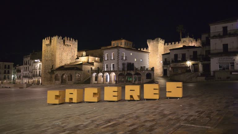 Large cheers sign in front of buildings in Caceres, Spain