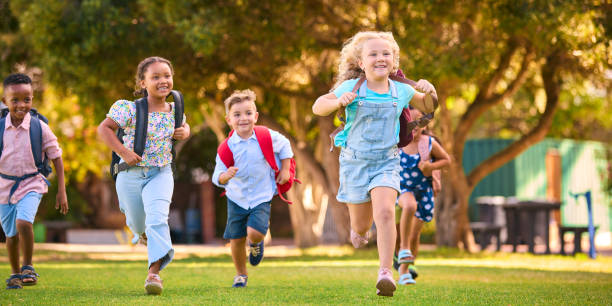 istock Multi-Cultural Primary Or Elementary School Students With Backpacks Running Outdoors At End Of Day 2098610199