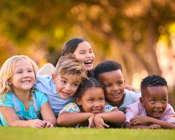 istock Portrait Of Multi-Cultural Primary Or Elementary School Student Friends Lying On Grass Outdoors 2098610200