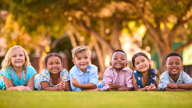 istock Portrait Of Multi-Cultural Primary Or Elementary School Student Friends Lying On Grass Outdoors 2098618037