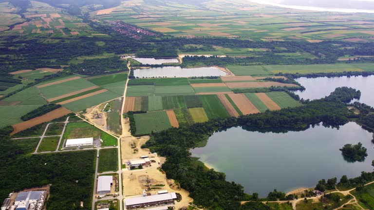 Drone flies above beautiful colorful plain countryside with lakes and ponds