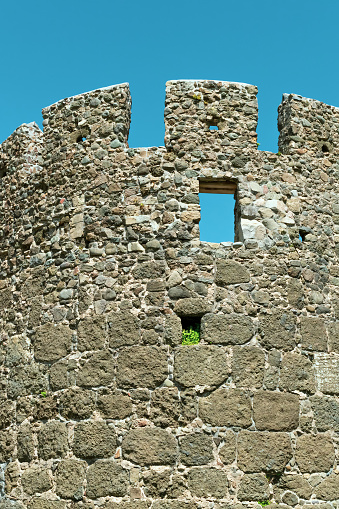 Stone wall of an ancient fortress. Sights and monuments. Defensive building.