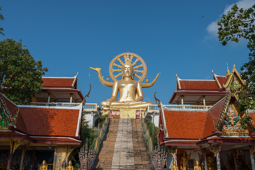 Golden buddha statue in the morning at Big Buddha Temple on Koh Samui island. Famous place for traveling. Religious arts and beliefs.