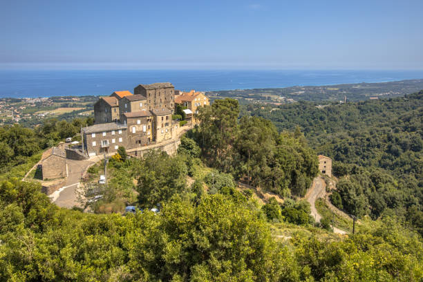 Ancient stone buildings perched on a rugged cliff overlooking the sea. Scenic coastal village with medieval architecture and ocean views. Picturesque seaside town with historic charm.
