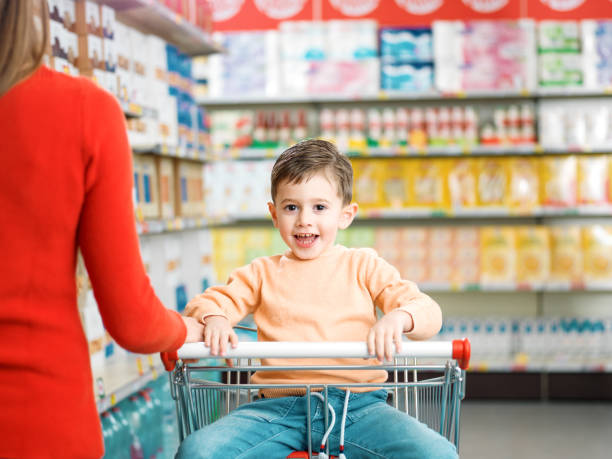 istock Cute happy boy doing grocery shopping with his mother 2098732724