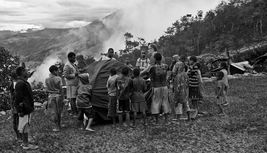 Baliem Valley, Wamena, West Papua, Indonesia - oct 30,2010 : Dani children helps hikers to assemble the tents for the night, Baliem Valley