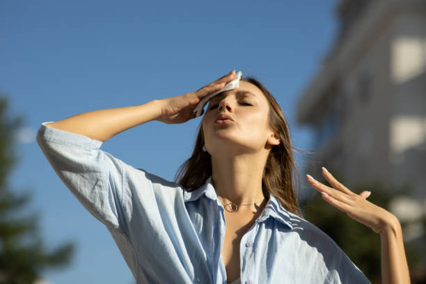 istock Woman drying sweat in a warm summer day 2098791308