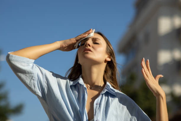 woman drying sweat in a warm summer day - glödande bildbanksfoton och bilder