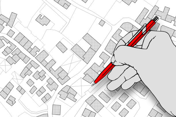 istock Architect drawing a residential building over an imaginary cadastral map of territory with buildings, fields and roads 2098816433