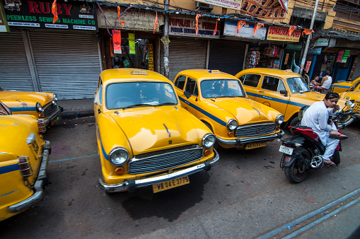 Kolkata, west Bengal. The traditional yellow taxies in the city street are waiting for the passengers in the evening.
