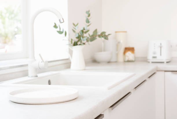 istock Empty round tray for product display on blurred kitchen sink counter and window sill background 2098864700