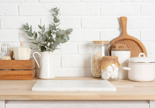 istock White stone podium on wooden kitchen counter with various rustic decor utensils and brick wall 2098865752