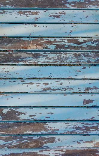 Aged Patina on Weathered Blue Wooden Boards. The Rustic Charm of Faded Paint and Time-Worn Wood. Outdoor