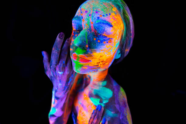 istock Portrait of a model with fluorescent makeup posing in UV light with colorful makeup 2098884549