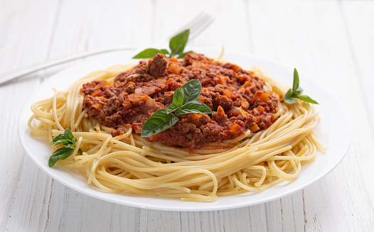 Traditional Italian pasta bolognese . Top view on wooden background