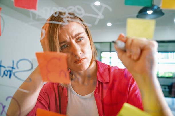 istock Young beautiful business leader writing marketing idea on board. Immaculate. 2098900826
