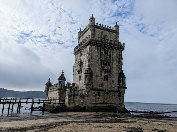 istock two towers on a beach and a body of water in front 2098912921