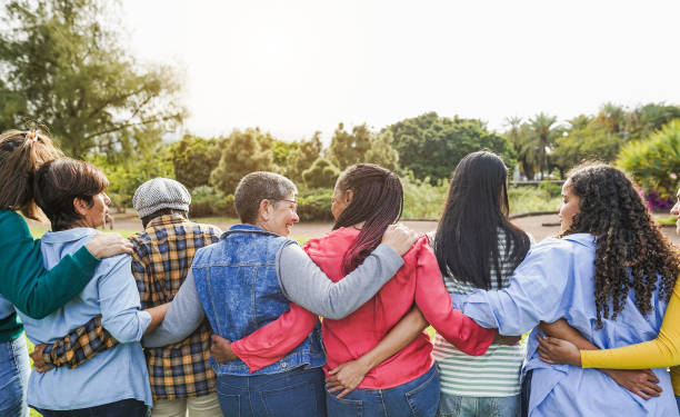 istock Multi generational women hugging each others - Female multiracial group having fun togheter outdoor - Firendship and people support concept - Main focus on african female head 2098940219