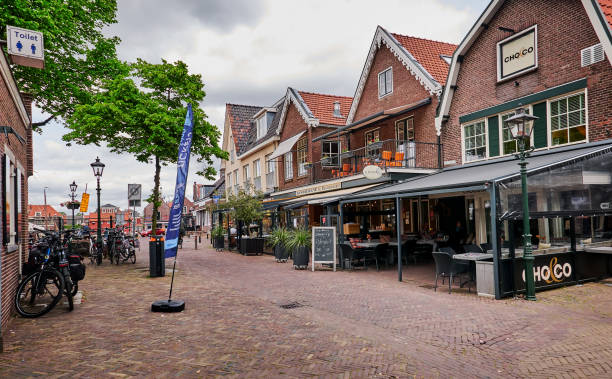 Street with old houses with cafe in the center of Spakenburg. stock photo