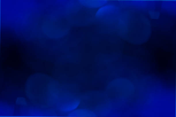 Abstract blue bokeh on the top and bottom black background. Beauty color backdrop for different design