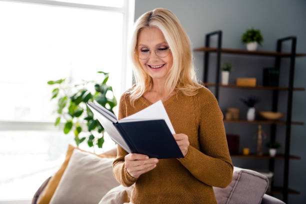 istock Photo of adorable intelligent retired lady reading weekly plan notebook planner workspace indoors 2098990494