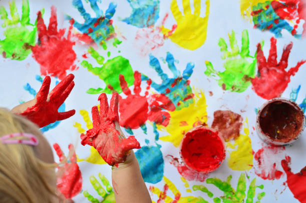 istock Playing and making multi colured handprint of child. 2099006602