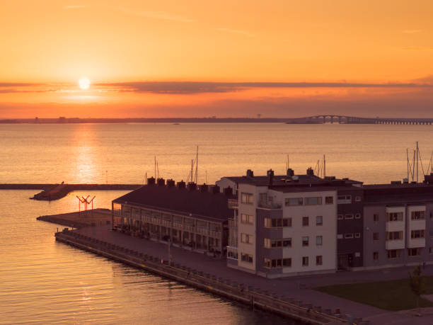 Apartment buildings by the sea in Färjestaden, Öland island, at sunset. In the background is the Öland bridge to mainland Sweden.