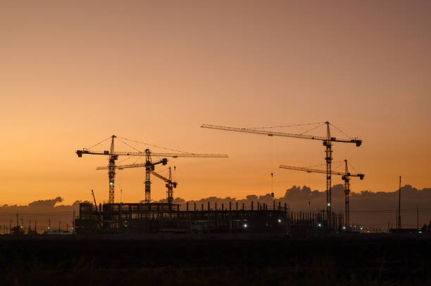 istock Silhouette of a building with backlit orange sky during sunset. 2099013981