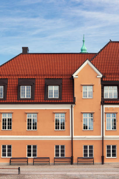 An old building at Stortorget town square with benches in front in central Karlskrona.