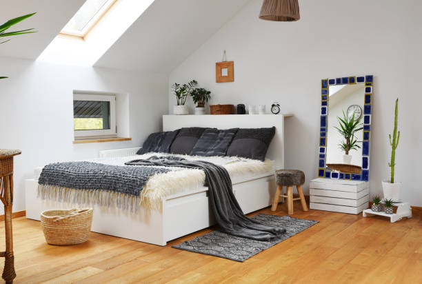 istock Home interior with Cosy bedroom in the attic in boho style with comfortable bed and grey pillow. 2099024348