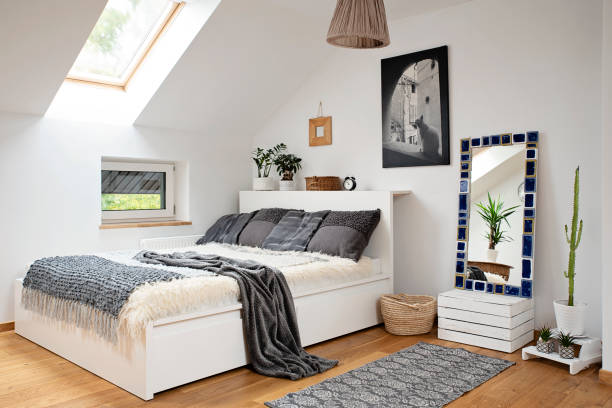 istock Home interior with Cosy bedroom in the attic in boho style with comfortable bed and grey pillow. 2099024350