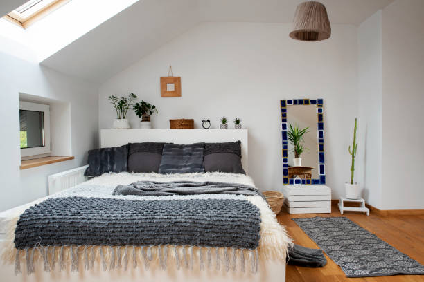 istock Home interior with Cosy bedroom in the attic in boho style with comfortable bed and grey pillow. 2099024358