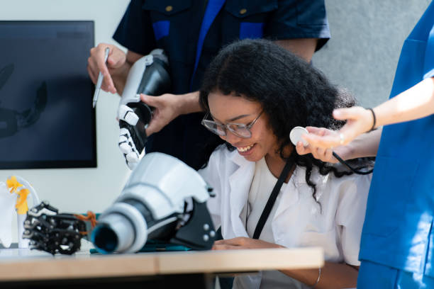 istock Engineers, doctors and physical therapists brainstorm ideas to design a robot with arm and hand organs, To be utilized for additional testing on patients. 2099025403