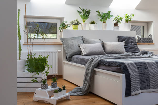 istock Home interior with Cosy bedroom in the attic in boho style with comfortable bed and grey pillow. 2099031590