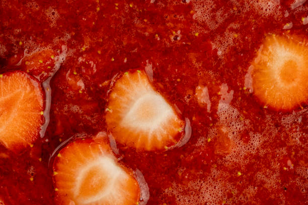 istock juice and pieces of strawberries after pressing 2099063055