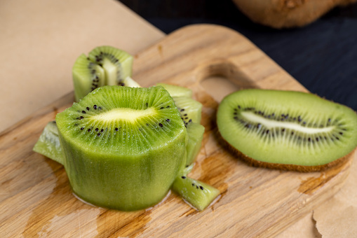 green ripe kiwi fruit on the table , cooking using kiwi green