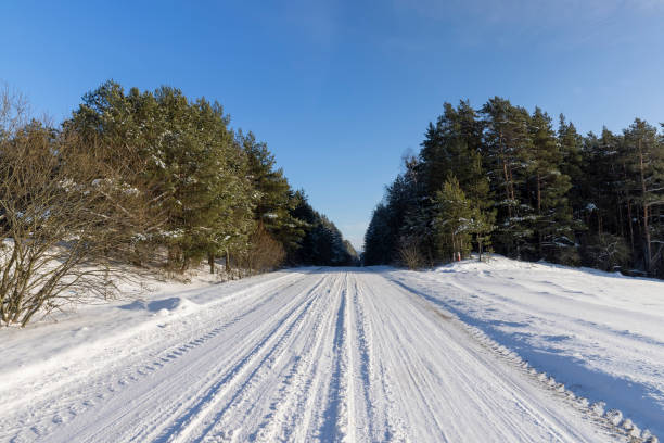 istock a slippery and dangerous road covered with snow 2099065854
