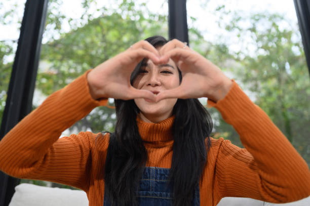 istock Focus on young woman's hands making heart sign with her hands 2099072734