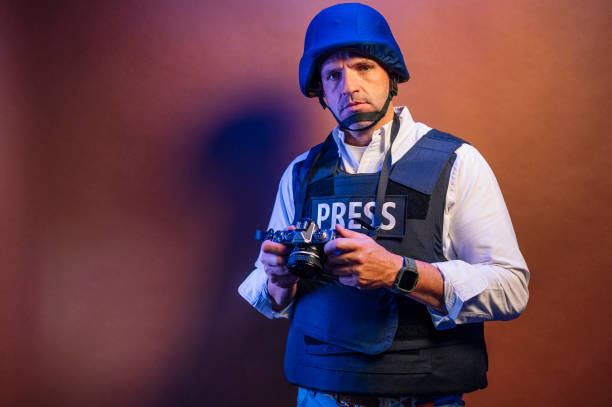 Reporter in bulletproof vest with a camera.