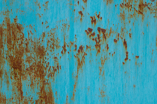 Abstract grungy old turquoise colored copper plate background that has oxidized and eroded, lots of pastel blues and turquoise colors.