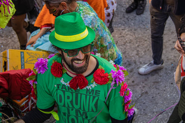 Athens, Greece - March, 2024. Disguised people in colourful costumes dance during the annual carnival parade at Metaxourgeio in Athens.
